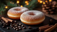 Sugar powdered donuts on dark background with coffee beans, cinnamon sticks and pine cones, festive winter mood with bokeh lights and evergreen branches.