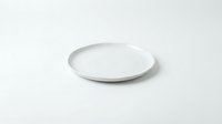 Empty white ceramic plate on clean white background isolated for kitchen dining restaurant food presentation design.