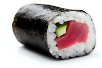 Fresh tuna roll with cucumber and rice wrapped in nori seaweed, macro food photography on white background showing texture and ingredients.