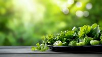 Fresh green vegetables and herbs on dark plate against blurred natural background with bokeh effect, perfect for healthy eating concepts.