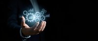 Businessman hand holding glowing digital icons with gears, charts, and graphs representing business analytics, data management, and technology solutions for corporate strategy.