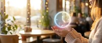 Woman holding glowing digital sphere in modern office environment with bokeh lights and blurred colleagues in background, representing innovation and technology solutions.