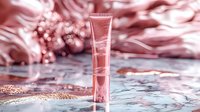 Luxurious cosmetic cream tube on rose gold background with glitter and silk fabric, elegant beauty product photography for skincare advertising.