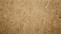 Natural brown cork board texture with organic grain patterns and small holes for bulletin boards and craft projects.