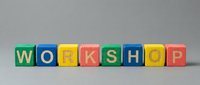 Colorful wooden toy blocks spelling WORKSHOP on a gray background, representing education, training, and skill-building events for business and learning concepts.