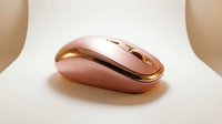 Elegant pink and gold wireless computer mouse on a neutral background, showcasing modern tech accessories for lifestyle and product design use.