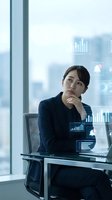 Asian businesswoman analyzing digital data charts and graphs in modern office with city view background for corporate presentations.