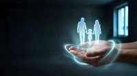 Glowing family silhouettes floating above protective hands in dark room with window light. Insurance protection concept for marketing materials.