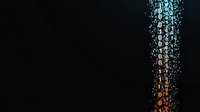 Digital binary code stream falling from top to bottom with orange and blue gradient color effect on dark background, representing data flow and technology concept.