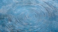 Mesmerizing circular ripples on tranquil blue water surface create hypnotic concentric patterns, reflecting light and movement in meditative aquatic composition.