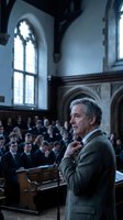 Distinguished middle-aged Caucasian professor delivering lecture in historic university hall with Gothic windows and wooden benches filled with attentive students.