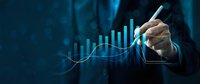 Businessman hand drawing upward trending graph with glowing blue data visualization charts showing financial growth and business success analytics.