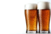 Two cold beer glasses with fresh amber lager and foam head, condensation droplets on glass surface against white background, close up view.