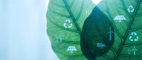 Green leaves with renewable energy symbols including solar panels wind turbines and recycling icons representing sustainable technology and eco-friendly solutions.