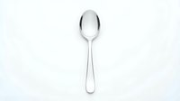 Single silver spoon isolated on white background for kitchen utensil design projects and culinary presentations.