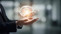 Businessman holding glowing brain hologram with network connections representing artificial intelligence, innovation and mental health concepts.