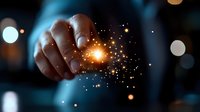Magical glowing sparkles and light particles floating from fingertips against dark background with bokeh effect, creating mystical atmosphere for fantasy designs.