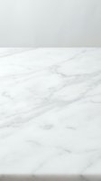 White marble surface with natural gray veining and soft shadows, suitable for luxury product displays, interior design backgrounds, and high-end commercial photography.
