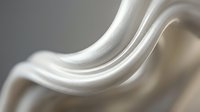 Smooth flowing white silk fabric with elegant curves and soft lighting creating luxurious textile waves for fashion and interior design projects.