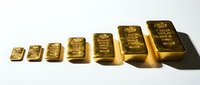 Golden bullion bars arranged in ascending size order on white background showcasing precious metal investment and wealth storage concept.