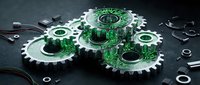 Interconnected green circuit board gears with metallic teeth on dark surface, symbolizing technology integration, digital systems, and mechanical engineering for industrial and tech concepts.