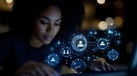 Young African American businesswoman using laptop with glowing social network icons and connections in dark office environment for digital marketing concepts.