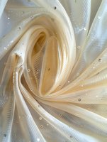 Luxurious cream-colored fabric with sparkly sequins swirled in elegant folds, creating soft waves and textural depth. Delicate tulle material catches light dramatically.