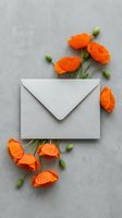 Gray envelope surrounded by vibrant orange poppy flowers and green buds on textured concrete surface for greeting cards and stationery designs.