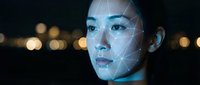 Asian woman with futuristic facial recognition technology overlay glowing in blue light against dark background with bokeh lights for AI concepts.