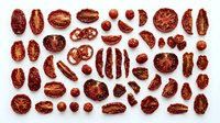 Overhead view of various dried red beans and legumes arranged on white background, isolated for culinary, nutritional, and design applications.