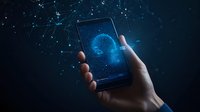 Digital hologram of glowing blue brain emerging from smartphone screen with network connections and particles in dark background, futuristic technology concept.