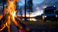 Campfire flames burning bright at dusk with RV motorhome parked nearby for outdoor adventure and recreational vehicle camping experience.