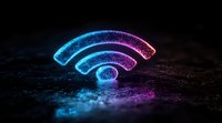 Glowing wifi symbol in neon blue and purple colors illuminated on dark textured surface with light reflection creating atmospheric technology concept.