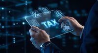 Businessman using digital tablet with holographic tax icons and financial symbols for accounting and business management solutions.