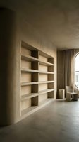 Modern minimalist interior with built-in wooden shelving unit and concrete floors in neutral earth tones for contemporary home design.