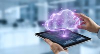 Business professional using tablet with glowing purple cloud computing network connection in modern office environment for digital transformation solutions.