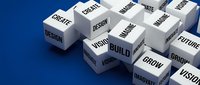 White cubes with business words like Build, Grow, Design, Create, Vision on blue background, representing innovation and creative strategy concepts.