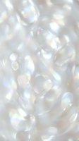 Iridescent mother of pearl texture with holographic shimmer and rainbow reflections creating luxurious nacre surface for jewelry and fashion design backgrounds.