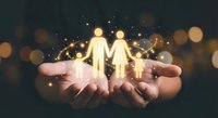 Glowing golden couple figures floating above open hands with magical bokeh lights representing love, relationships, protection and care in romantic setting.