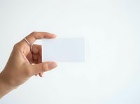 Hand holding blank white card isolated on light background, ready for branding, business identity, or promotional design mockup.