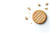 Round crispy cracker with small holes and scattered crumbs on white background, isolated food photography for commercial and packaging design.