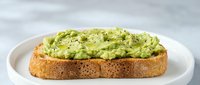 Fresh avocado toast on whole grain bread served on white plate, healthy breakfast or snack option for nutritious eating and wellness lifestyle.