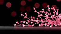 Pink crystal branch formation with delicate buds and stems against dark background creates elegant minimalist composition for luxury design projects.