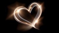Glowing golden heart shape created with light trails on black background for romantic designs and Valentine's Day projects.