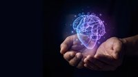Hands holding glowing digital brain with neural networks on dark background representing artificial intelligence, machine learning and cognitive technology.