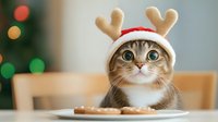Adorable tabby cat wearing festive reindeer antlers hat sitting at table with Christmas cookies, perfect for holiday greeting cards and seasonal marketing.