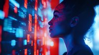 Young African American woman in profile illuminated by futuristic red and blue digital projections, looking at holographic data displays in dark environment.