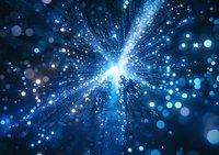 Glowing blue particles and light rays bursting from center point against dark background create dynamic cosmic explosion effect for technology backgrounds.