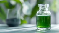Glass bottle with green liquid on light background with natural shadows and bokeh effect, wellness and aromatherapy concept for spa and relaxation.