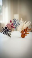Dried flower arrangement with colorful blooms and pampas grass in white vase on neutral background for home decor and botanical design projects.